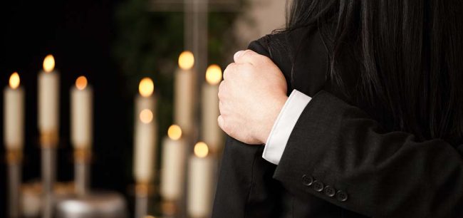 20 questions to ask a funeral director woman being comforted at a funeral