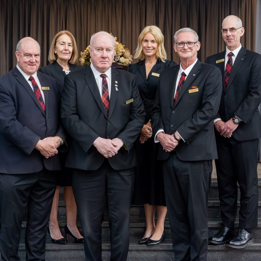 Team at Anton Brown Funerals standing on a set of stairs